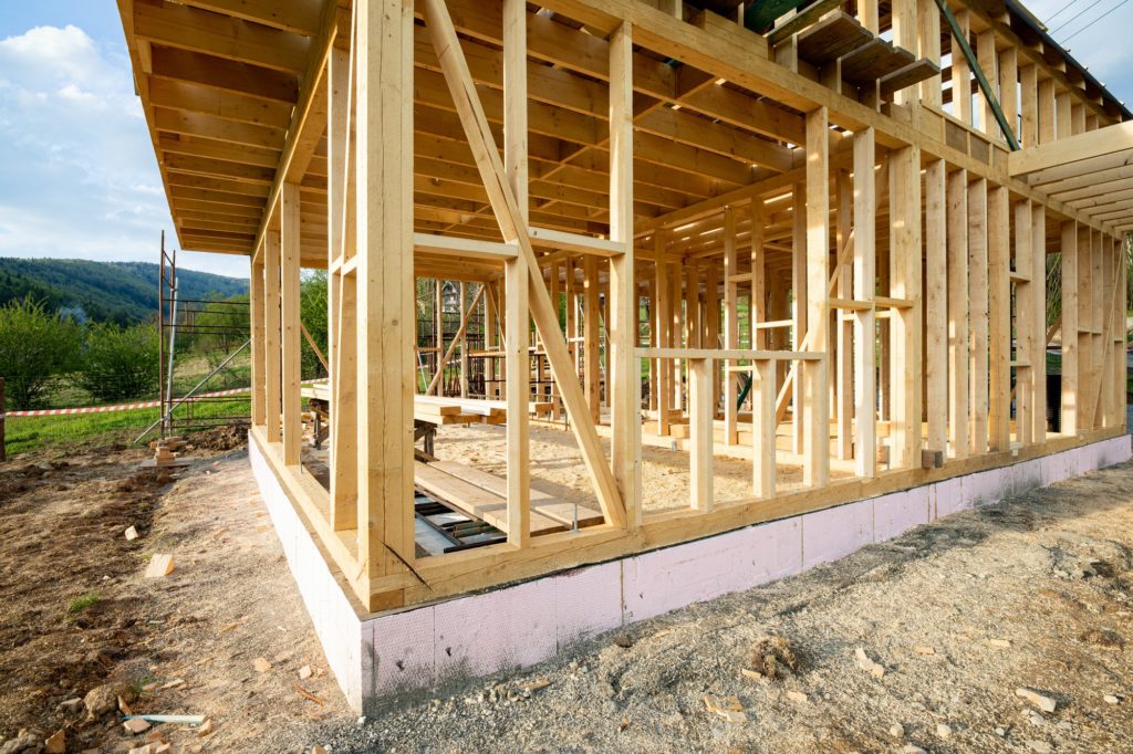 New wooden frame house under construction, outdoor residential home